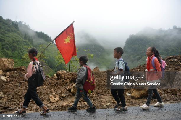 Primary school students walk to school, which takes about 40 minutes, on September 3, 2020 in Jinyang County, Sichuan Province of China.