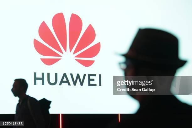 People arrive to attend the Huawei keynote address at the IFA 2020 Special Edition consumer electronics and appliances trade fair on the fair's...