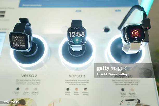 Fitbit health smartwatches lie on display at the Fitbit stand at the IFA 2020 Special Edition consumer electronics and appliances trade fair on the...