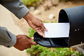 Man taking an envelope out of his mailbox