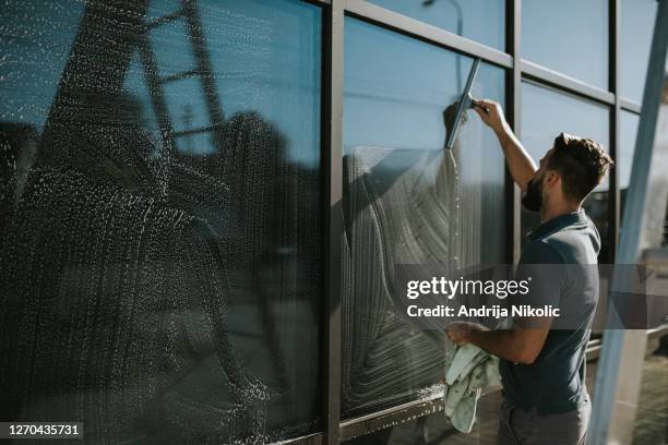 window cleaners working together - window cleaning stock pictures, royalty-free photos & images