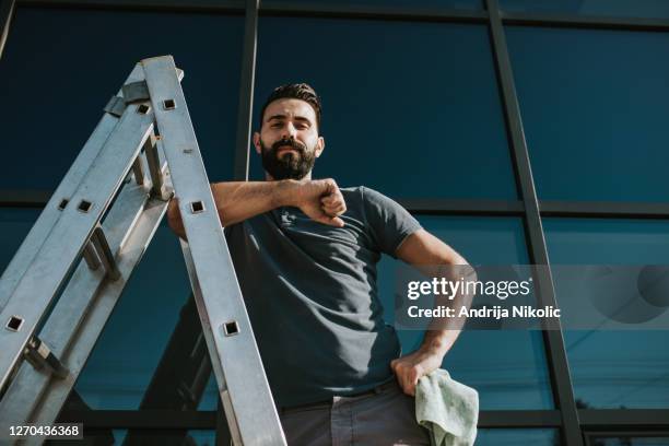 window cleaner on his job - window cleaning stock pictures, royalty-free photos & images