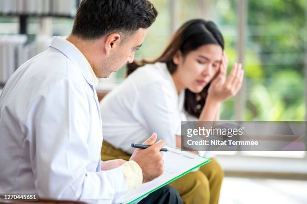 caucasian mental disorder specialist comforting to female patient. selective focus on doctor. support, consoling, therapist. - hôpital psychiatrique photos et images de collection