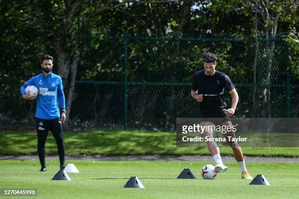 Fabian Schär controls the ball under the watchful eye of Strength and Conditioning Coach Cristian Fernandez during the Newcastle United Training...