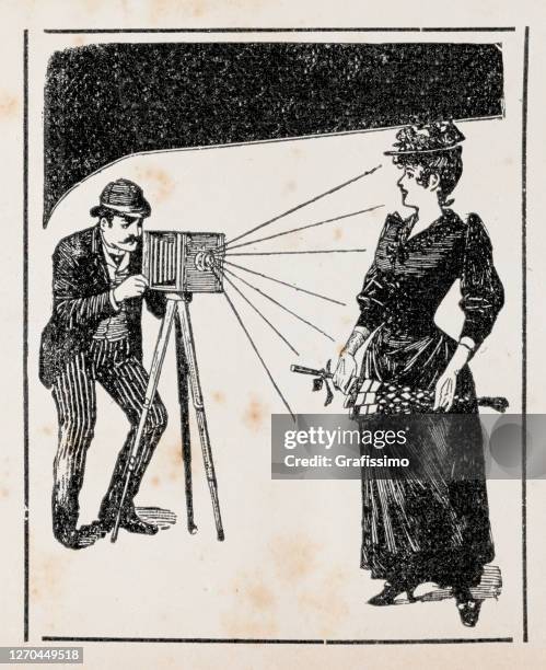 photographer taking photo of woman 1899 illustration - photographer stock illustrations