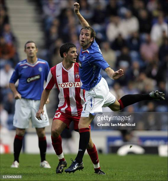 Dorde Tutoric of Red Star Belgrade and Kirk Broadfoot of Rangers are seen during the Uefa Champions league 3rd Round Qualifier match between Rangers...