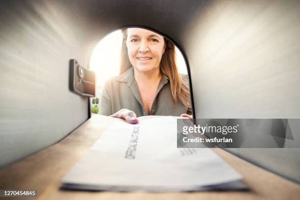 woman checking mailbox - voting by mail stock pictures, royalty-free photos & images