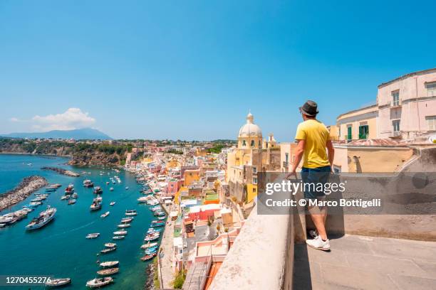 man admiring the cityscape in procida, italy - naples italy church stock pictures, royalty-free photos & images