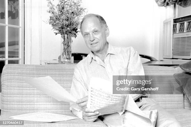 Portrait of American composer and lyricist Charles Strouse as he holds sheet music at the Yamaha Showroom, New York, New York, August 10, 1995.