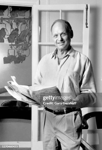 Portrait of American composer and lyricist Charles Strouse as he holds sheet music at the Yamaha Showroom, New York, New York, August 10, 1995.