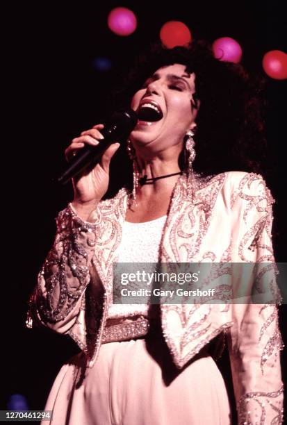 American Pop and Dance singer Cher performs onstage at the Jones Beach Marine Theater , Wantagh, New York, July 16, 1990.