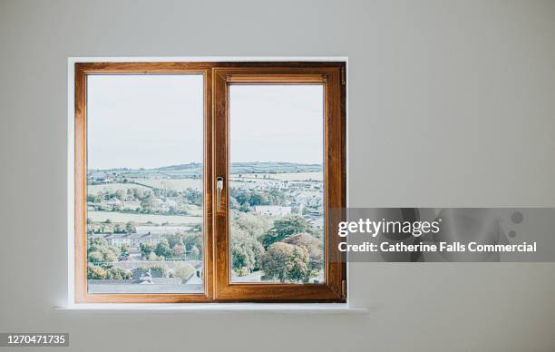 wooden window frame set in a plain white wall - window fotografías e imágenes de stock