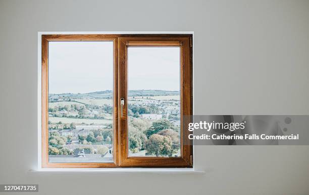 wooden window frame set in a plain white wall - wood window frames stock pictures, royalty-free photos & images
