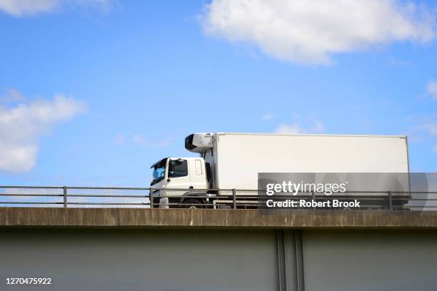 refrigeration lorry travelling along overpass. - refrigerator truck stock pictures, royalty-free photos & images