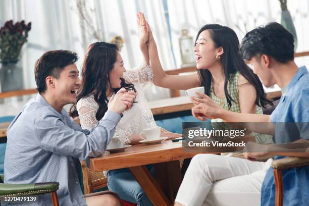 young friends in a cafe to chat - social content stock pictures, royalty-free photos & images