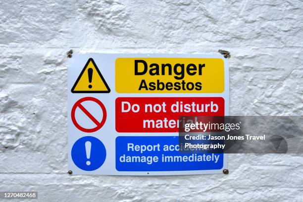 an asbestos warning sign on the outside of a building in harris - asbestos stock pictures, royalty-free photos & images