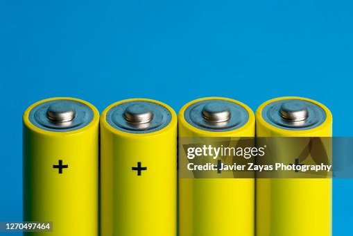Four Yellow Batteries On Blue Blackground Four Yellow Batteries On Blue Blackground