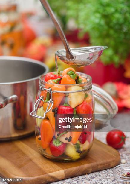 preserving chili peppers in the jars - preserved in oil stock pictures, royalty-free photos & images
