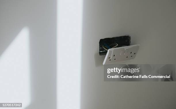 plug socket hanging off a freshly plastered wall in a new build - plug socket stock pictures, royalty-free photos & images