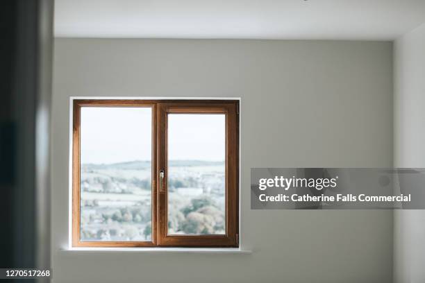 wooden window frame set in a plain white wall in an empty room - window sill stock pictures, royalty-free photos & images