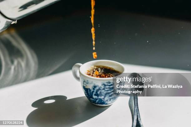 pouring coffee into espresso coffee cup - blue and white porcelain style stock pictures, royalty-free photos & images