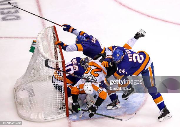 Scott Mayfield of the New York Islanders checks James van Riemsdyk of the Philadelphia Flyers into Semyon Varlamov and Andy Greene during the second...