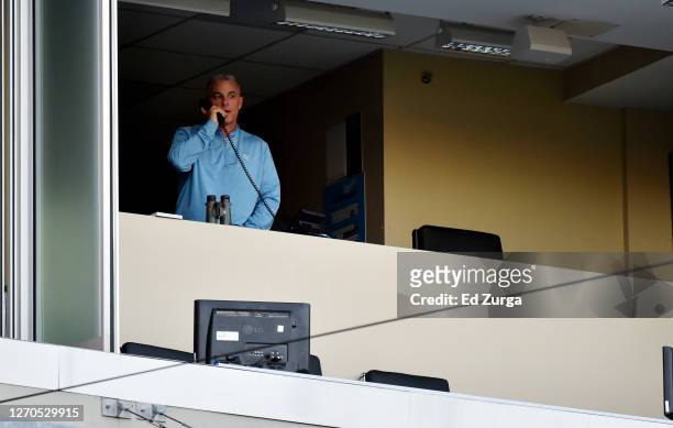 General manager Dayton Moore of the Kansas City Royals talks on the phone prior to a game against the Chicago White Sox at Kauffman Stadium on...