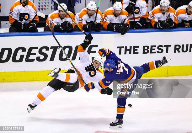 Ivan Provorov of the Philadelphia Flyers and Jordan Eberle of the New York Islanders collide during the first overtime period in Game Six of the...