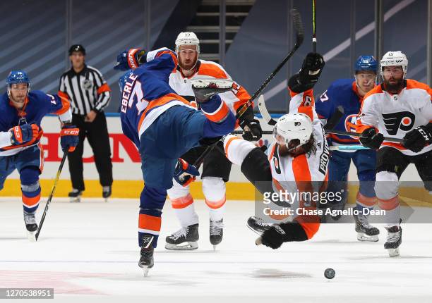 Jordan Eberle of the New York Islanders checks Ivan Provorov of the Philadelphia Flyers in the first overtime period of Game Six of the Eastern...
