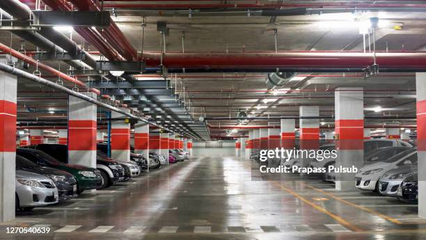 parking garage, underground interior with a few parked cars - subterrâneo imagens e fotografias de stock