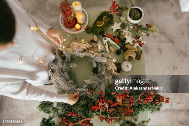 making my christmas wreath - decorating the christmas tree stock pictures, royalty-free photos & images