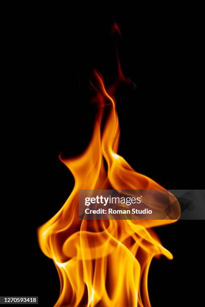 fire flames on black background - flamme stock-fotos und bilder