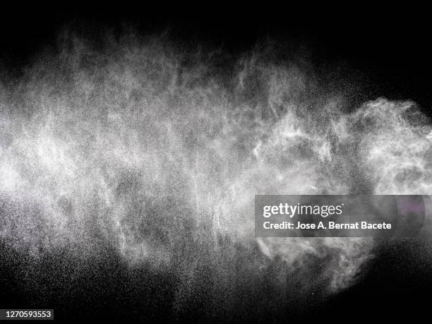 full frame of the textures formed  by the water jets to pressure with drops floating in the air of color white on a black background - nebulizador fotografías e imágenes de stock