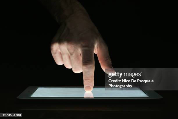 man using digital tablet - touchpad fotografías e imágenes de stock
