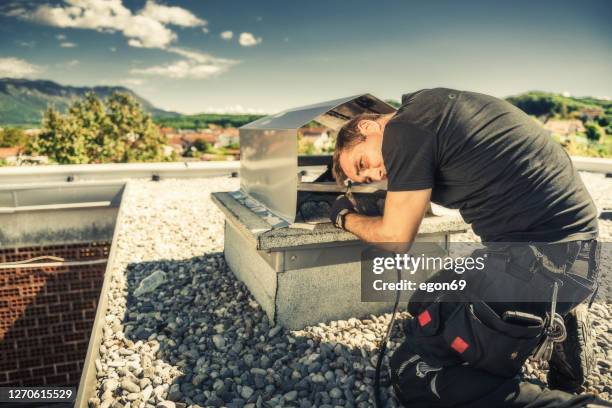 schoorsteenveger die een schoorsteen schoonmaakt - vegen stockfoto's en -beelden