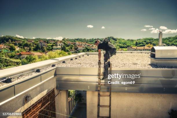 chimney sweeper climbs on the roof - chimney sweeping stock pictures, royalty-free photos & images