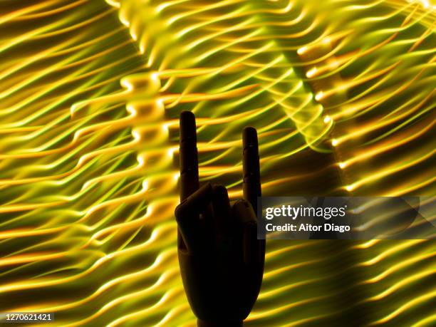 hands doing the rock sign reflected with a black background. - heavy metal horns stock pictures, royalty-free photos & images