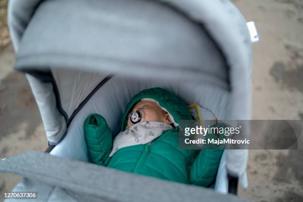 sweet baby in stroller stock - winter baby stock pictures, royalty-free photos & images