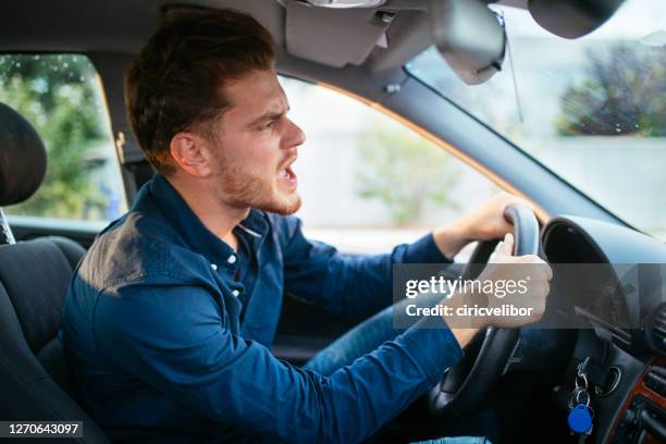 young man getting mad on the road - road rage stock pictures, royalty-free photos & images