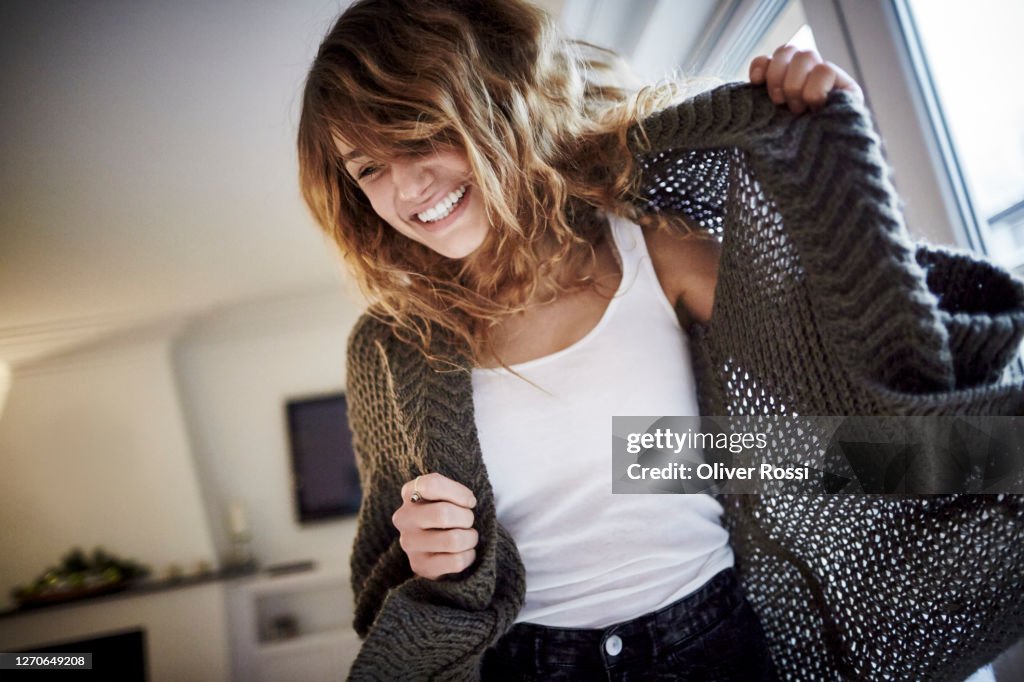Cheerful young woman at home