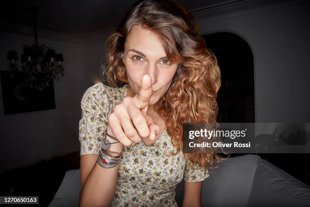 portrait of a young woman pointing her finger - pointing stock pictures, royalty-free photos & images