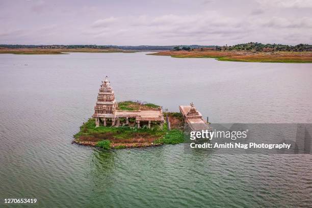 aerial view of the ancient sangameshwara temple in the middle of the tippagondanahalli reservoir - monument india stock pictures, royalty-free photos & images