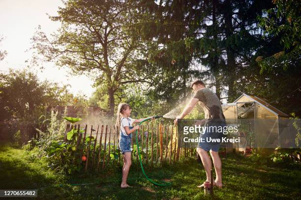 father and daughter having fun in garden - naughty daughter stock pictures, royalty-free photos & images