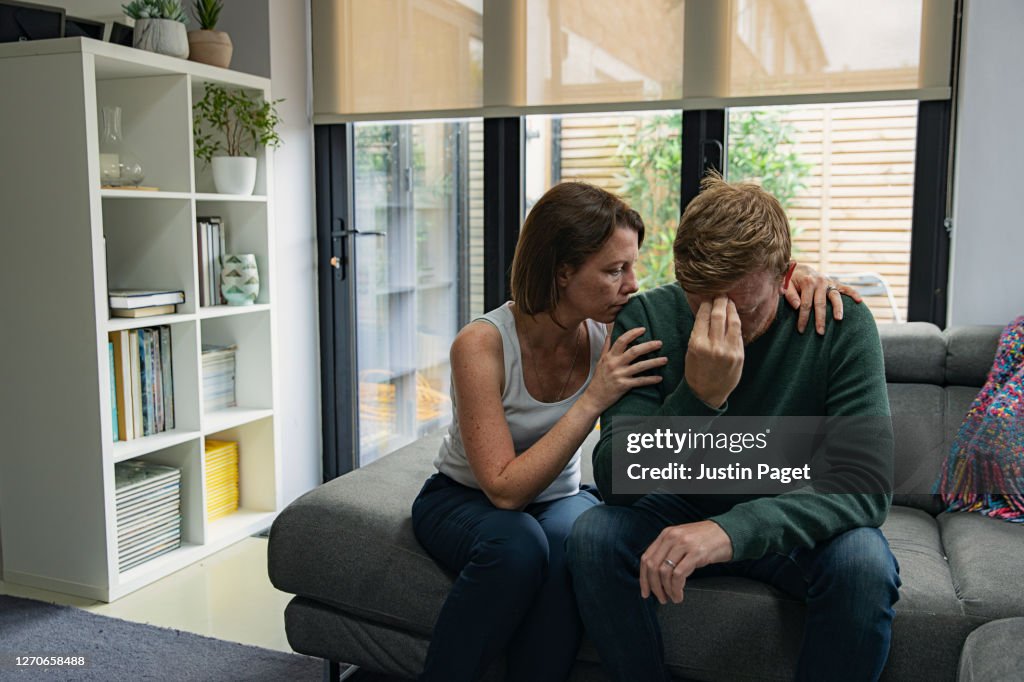 Woman comforting upset man