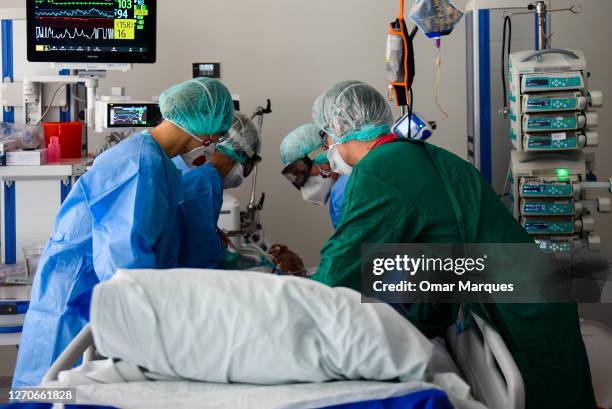 Medical personnel wear protective suits, masks, gloves and face shields during their shift at the ICU of Krakow University Hospital on September 04,...