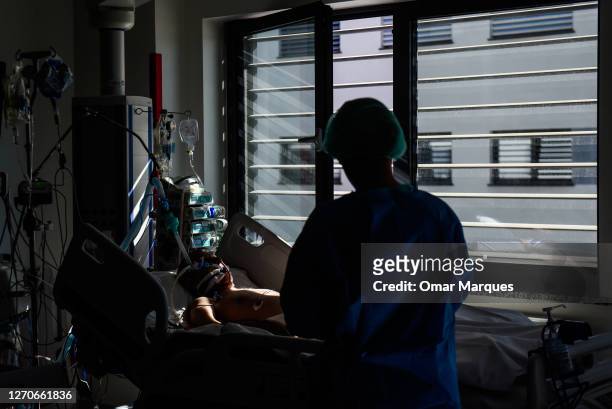 Patient rest on the bed next to a window at the ICU of Krakow University Hospital on September 04, 2020 in Krakow, Poland. Poland has banned flights...