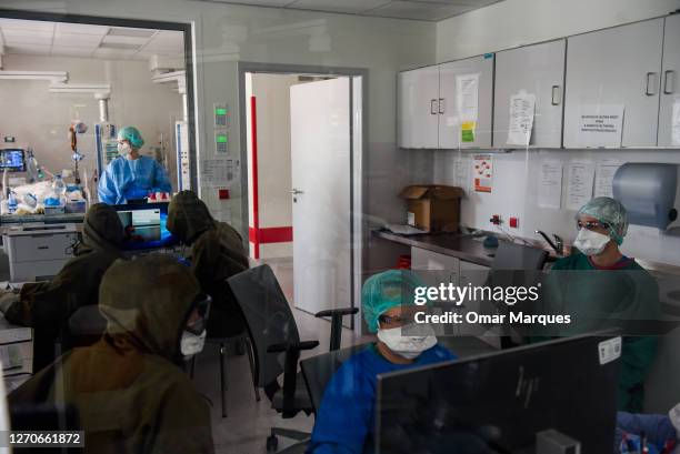 Medical personnel wear protective suits, masks, gloves and face shields during their shift at the ICU of Krakow University Hospital on September 04,...