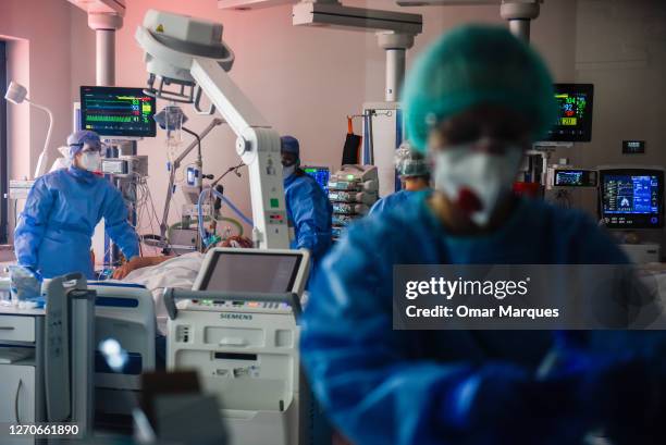 Medical personnel wear protective suits, masks, gloves and face shields during their shift at the ICU of Krakow University Hospital on September 04,...