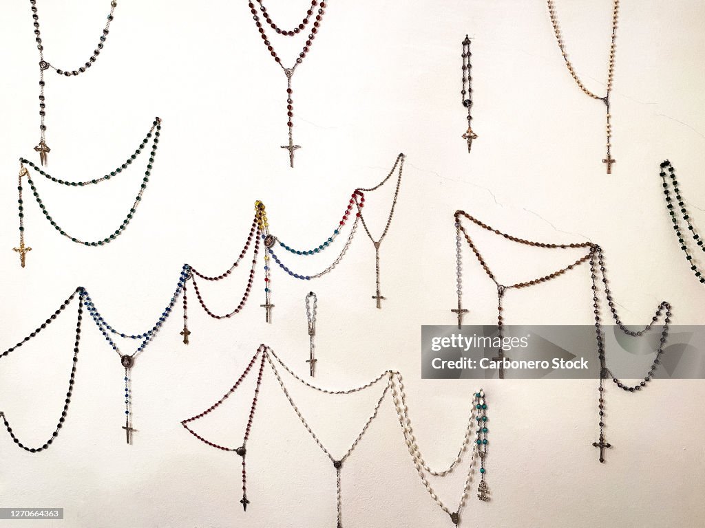 Rosaries hanging on the wall