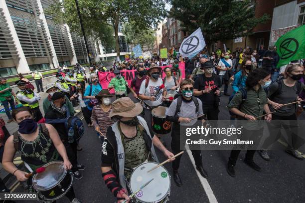 Extinction Rebellion activists protest against climate change and the plight of refugees outside the Home Office on September 4, 2020 in London,...